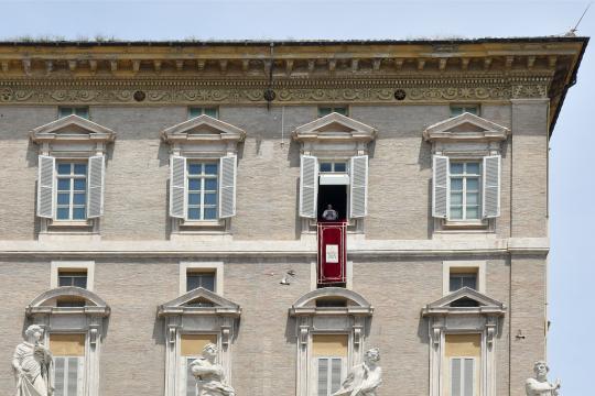 Pope Francis addresses the crowd from the window of the apostolic palace overlooking St.Peter's square during his Sunday Angelus prayer at the Vatican on June 13, 2021.  