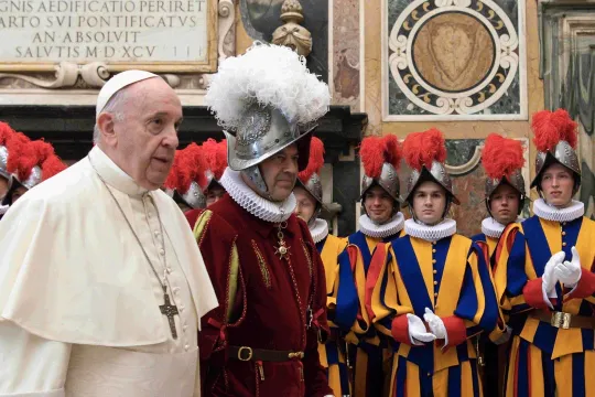 This photo taken and handout on October 2, 2020 by The Vatican Media shows Pope Francis (L) presides over a ceremony in The Vatican's Clementine Hall, for the new Recruits of the Pontifical Swiss Guard. 