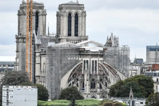 This photograph taken on August 19, 2021 in Paris, shows a giant crane outside Notre-Dame Cathedral, which was partially destroyed when fire broke out