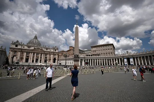 Tourists and locals walk in St. Peter's Square in the Vatican City, on June 11, 2023. Pope Francis, on the advice of doctors, skipped the usual Angelus prayer from the apostolic palace in St. Peter's Square after undergoing an operation for an abdominal hernia on June 7 at a Rome hospital, which was completed 'without complications', the Vatican said. Tiziana FABI / AFP
