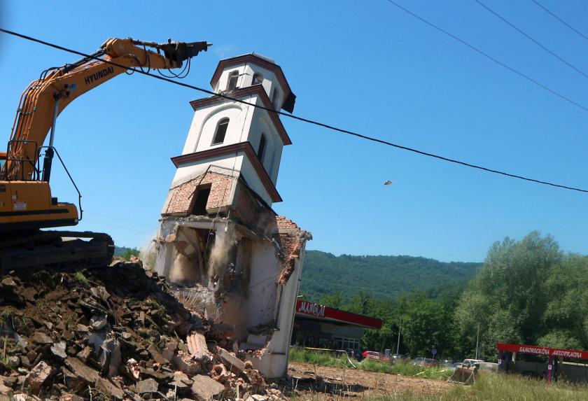A digger demolishes an illegally constructed Serbian Orthodox church in Konjevic Polje, Eastern Bosnia on June 5, 2021, which was built in 1998 on land near Srebrenica, seized from Fata Orlovic, a Muslim refugee after the 1992-1995 civil war. The demolition began more than a year and a half after the European Court of Human Rights (ECHR) ordered the destruction of the church, which had been built on land owned by Muslims forced to flee during the war.  STR / AFP
