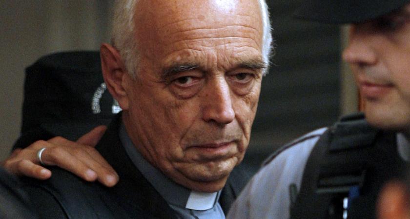 Former Buenos Aires' provincial police chaplain Christian Von Wernich, is escorted in court before the start of the last day of his trial in La Plata, province of Buenos Aires, on October 9th, 2007. A verdict in Von Wernich's trial, accused of collaborating in several murders, kidnappings and tortures during Argentina's 1976-1983 military dictatorship and imprisoned since 2003, is expected later today following a three-month trial, while prosecutors yesterday pressed for life in jail. Von Wernich, 69, is th
