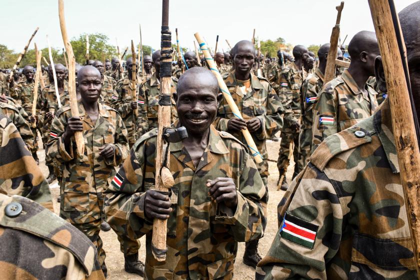 New members of South Sudan People's Defence Forces (SSPDF) of the Unified Forces attend with handmade wooden rifles or sticks during the graduation ceremony in Malakal on November 21, 2022. About nine thousand members including former soldiers of rebels in South Sudan's civil war were integrated into the country's Unified Forces after more than 3 years of training. Samir Bol / AFP