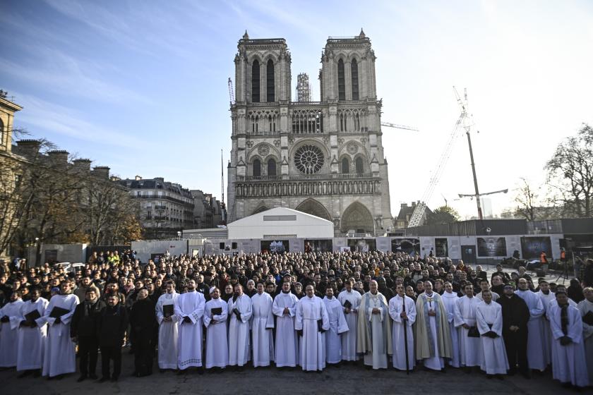 Six hundreds seminarians from the Catholic Church pose after a prayer service in front of Notre-Dame de Paris Cathedral, in Paris, on December 2, 2023. More than 600 seminarians gathered since December 1, 2023 in Paris, for a big national gathering, the first in nine years. JULIEN DE ROSA / AFP