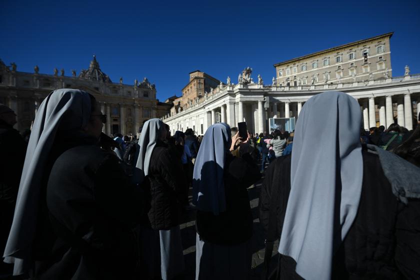 Nuns listen to Pope Francis as he addresses the crowd from the window of the apostolic palace overlooking St. Peter's square during the weekly Angelus prayer on January 21, 2024 in The Vatican. Filippo MONTEFORTE / AFP