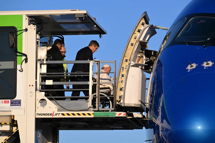 Pope Francis, seated on a wheelchair (C), is lifted on a platform to board his plane on January 31, 2023 at Rome's Fiumicino airport, heading to Democratic Republic of Congo and South Sudan. Pope Francis heads to Democratic Republic of Congo and South Sudan, delivering a message of peace and reconciliation to two sub-Saharan African nations plagued by conflict. The pontiff flies to the Congolese capital Kinshasa on January 31 before heading on Friday to Juba, the capital of South Sudan where he will be join