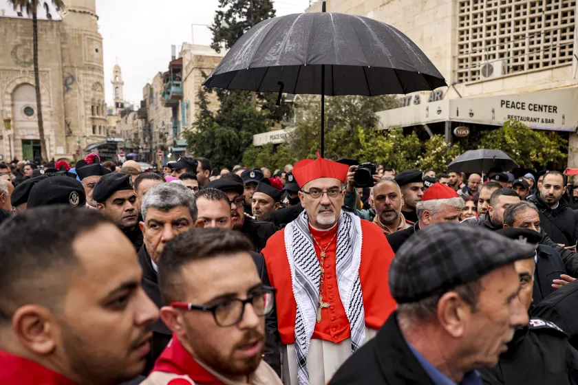 Latin Patriarch of Jerusalem Pierbattista Pizzaballa (C) arrives for Christmas Eve celebrations (according to Western tradition) at the Manger Square outside the Church of the Nativity in the biblical city of Bethlehem in the occupied West Bank on December 24, 2023.  HAZEM BADER / AFP