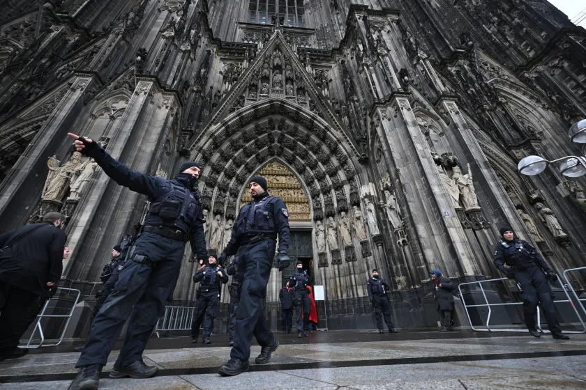 Policemen stand in front of the Cologne Cathedral on December 24, 2023. German police announced on December 23, 2023 evening they were searching the cathedral in the western city of Cologne with sniffer dogs following a "danger warning" for New Year's Eve. The German daily Bild reported that officials in Austria, Germany and Spain have all received indications that an Islamist group was planning several attacks in Europe, possibly on New Year's Eve and Christmas. INA FASSBENDER / AFP