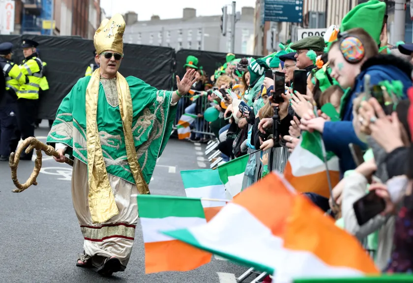 An actor dressed as St Patrick works the crowd as revellers attend the annual St Patrick's Day parade in Dublin 